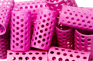 closeup of a few pink hair curlers