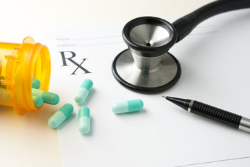 Prescription medicine with stethoscope and pen