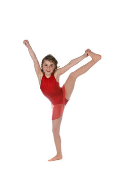 young girl doing a split and wearing red leotard