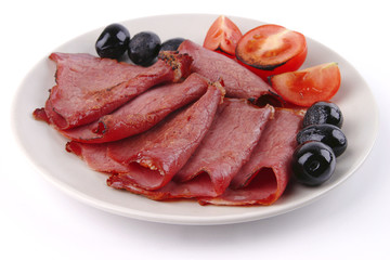 sliced served sausage with raw tomato