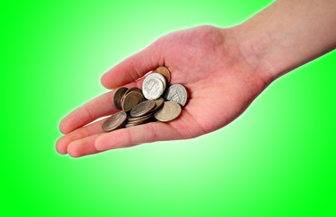 Hand holding pile of coins