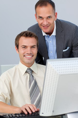 Assertive business partners working together at a computer