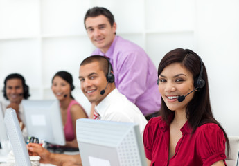 Positive business people with headset on working