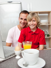 Happy father and his son having breakfast