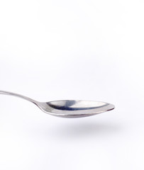 old metal spoon with white background close up