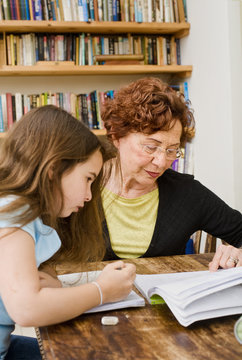 senior halping child doing homework