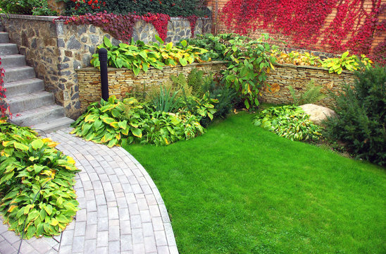Garden stone path with grass growing up between the stones
