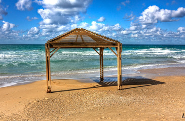 Sea shore and wooden sun shelters, Netanya, Israel