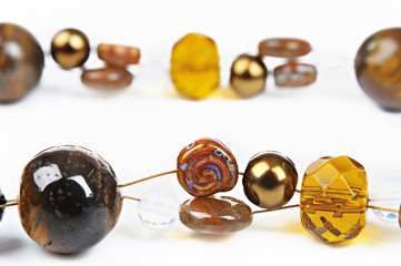 brown glass beads with shell on a white background