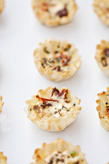 Mini savory goat cheese, basil and sun dried tomato tarts.