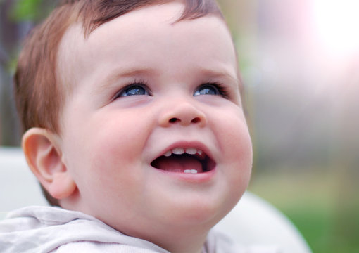 Portrait of a smiling baby boy outdoors