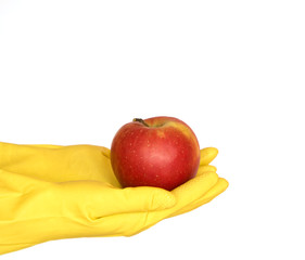 apple on yellow gloves, white background