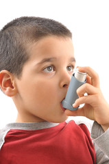 Close up image of a cute little boy using inhaler for asthma