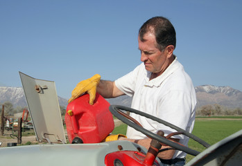 farmer gassing tractor