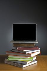 Stack of book and laptop