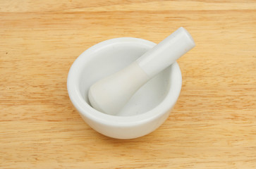 Pestle and mortar on wood