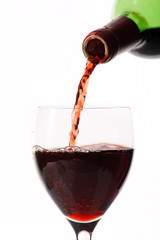 Red wine poured in a glass.
