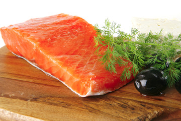 pink salmon on wooden plate with cheese