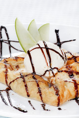 apple cake and ice-cream on a white plate