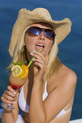 Beutiful Blond Girl In Bikini Drinking Cocktail By The Sea