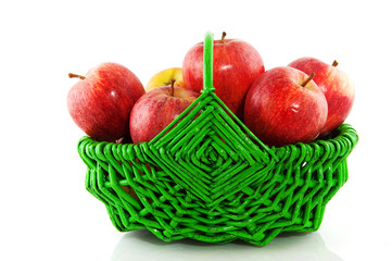 Red apples in green basket