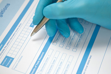 Doctor Completing Blood Test Form