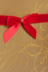 Parcel with gold paper and red ribbon