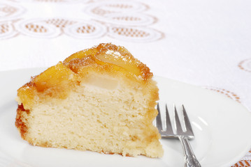 slice of upside down pear cake with a fork
