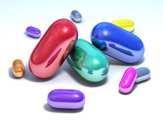 Shiny multicolored capsules on a white floor.