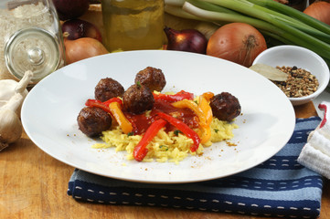 organic rice with grilled meatballs on a plate