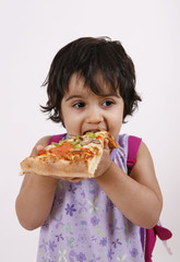 girl enjoying pizza slice