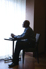 Businessman Sitting by Cafe Window