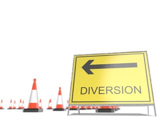 A diversion sign with road cones in the background