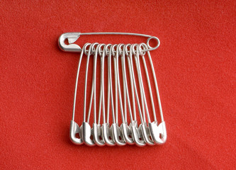 pins in silver over red background
