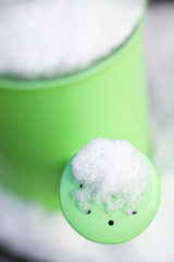 Watering can covered with snow