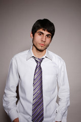 Businessman putting on tie