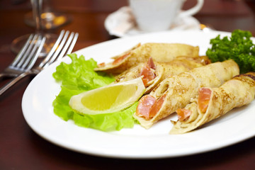 Pancakes with a salmon on a plate