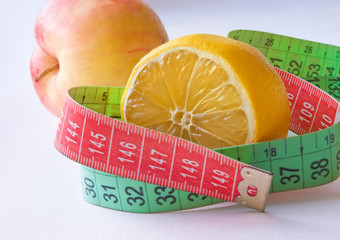 Tape measure with lemon and red apple