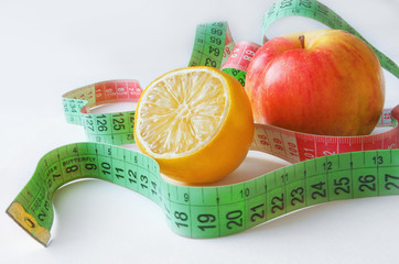 Tape measure with lemon and red apple