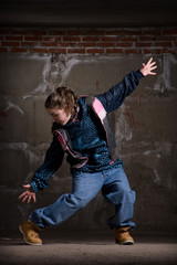 Hip hop dancer in modern style over brick wall