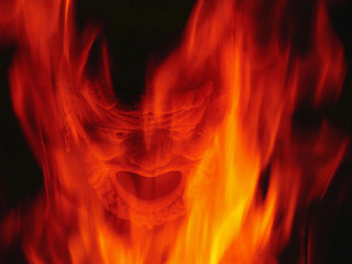 Fireplace burning with Devil mask