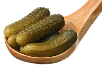 Marinaded cucumbers in a wooden spoon