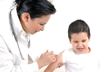 Pediatrician giving an injection in arm to a little boy