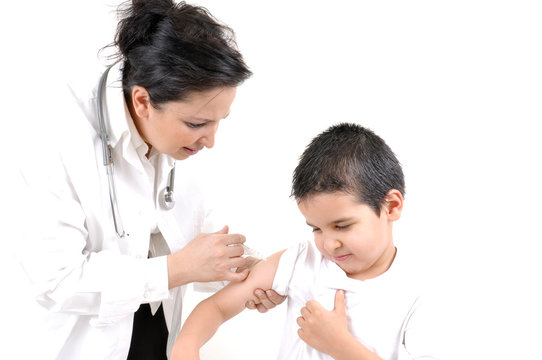 Pediatrician giving an injection in arm to a little boy