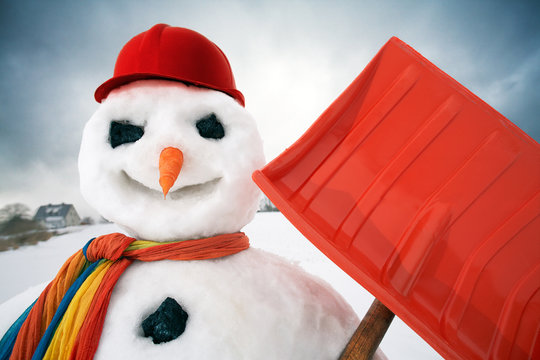 portrait of a friendly snowman with a snow shovel