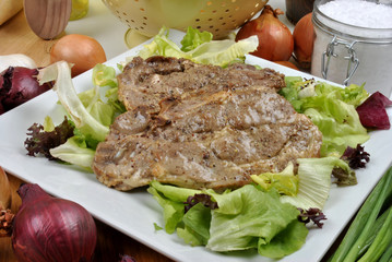 spare rib chops on a plate with salad