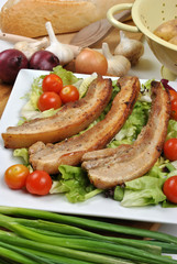 boneless streaky slices on a plate with salad