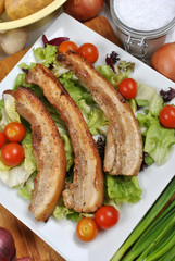 boneless streaky slices on a plate with salad