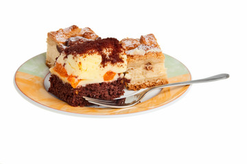 Apple and orange cakes on a plate with fork.