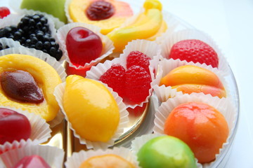Candies in the form of fruits on a white background